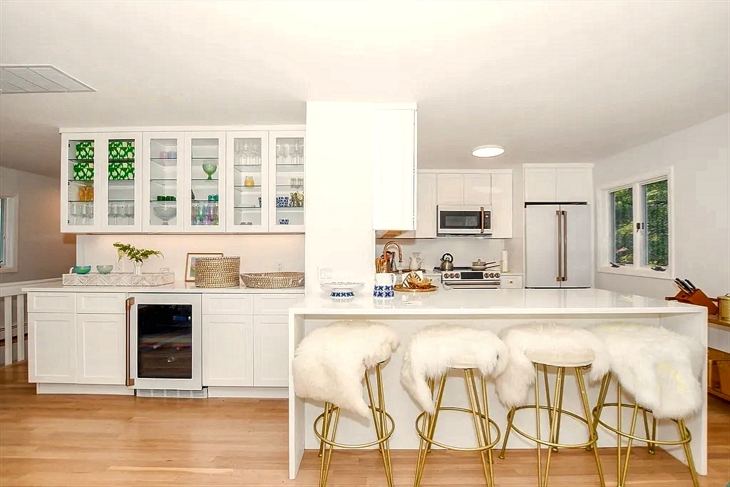 Family room with wet bar, wood counter and open shelving — an easy second gathering spot.