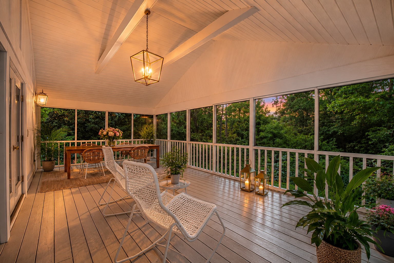 Screened three-season porch at dusk with warm lantern light at 44 Register Road, Piney Point